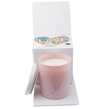 Set the Mood for Love with Pink Love Geranium & Peppermint Candle A couple enjoying a romantic evening with the Pink Love Geranium & Peppermint Soy Candle lit on a side table.