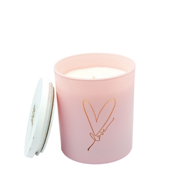 Pink Love Candle Illuminates Room with Relaxing Fragrance Close-up of the burning Pink Love Geranium & Peppermint Soy Candle with a soft pink glow.