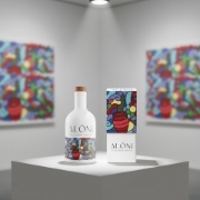 The ALÓNI 'The Grove' art bottle, designed by Soteur, displayed as a collector's item on a pedestal in a modern art gallery.